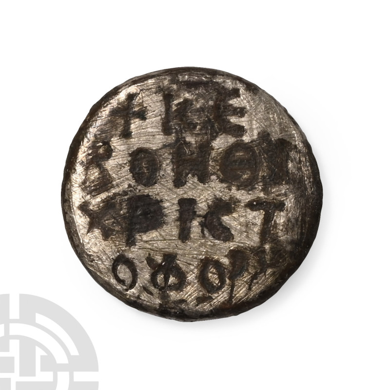 Circa 6th-12th century A.D.. Discoid-shaped with Greek inscription in four lines...