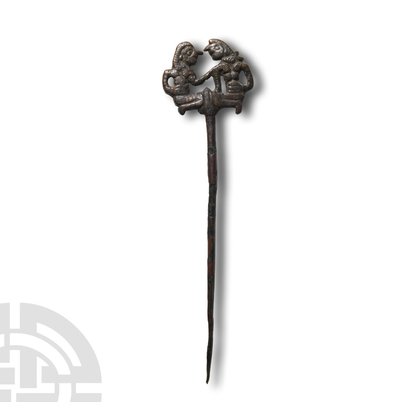 1180-700 B.C.. With tapering shaft and openwork bifacial finial depicting two kn...