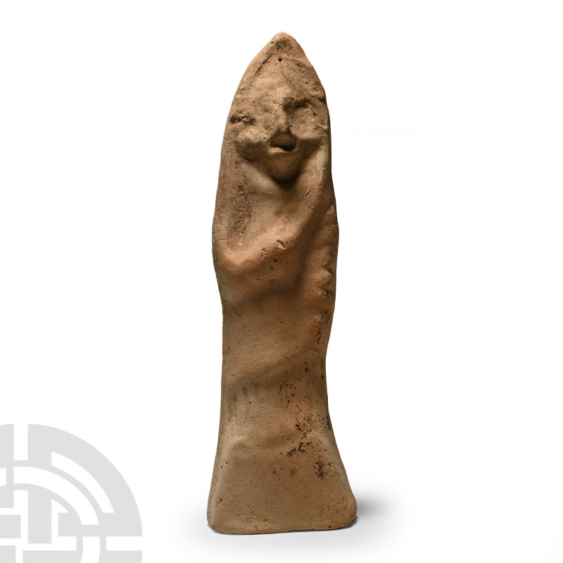 1st millennium B.C.. Hollow-formed and wearing a peaked headdress, left hand cla...