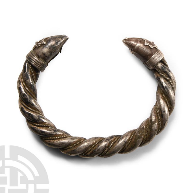 12th-14th century A.D.. Penannular hoop with twist detailing and applied twisted...