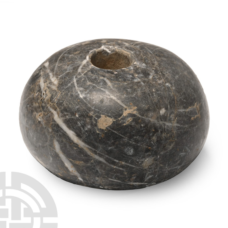 2nd-1st millennium B.C.. Donut-shaped and drilled vertically to accommodate a wo...