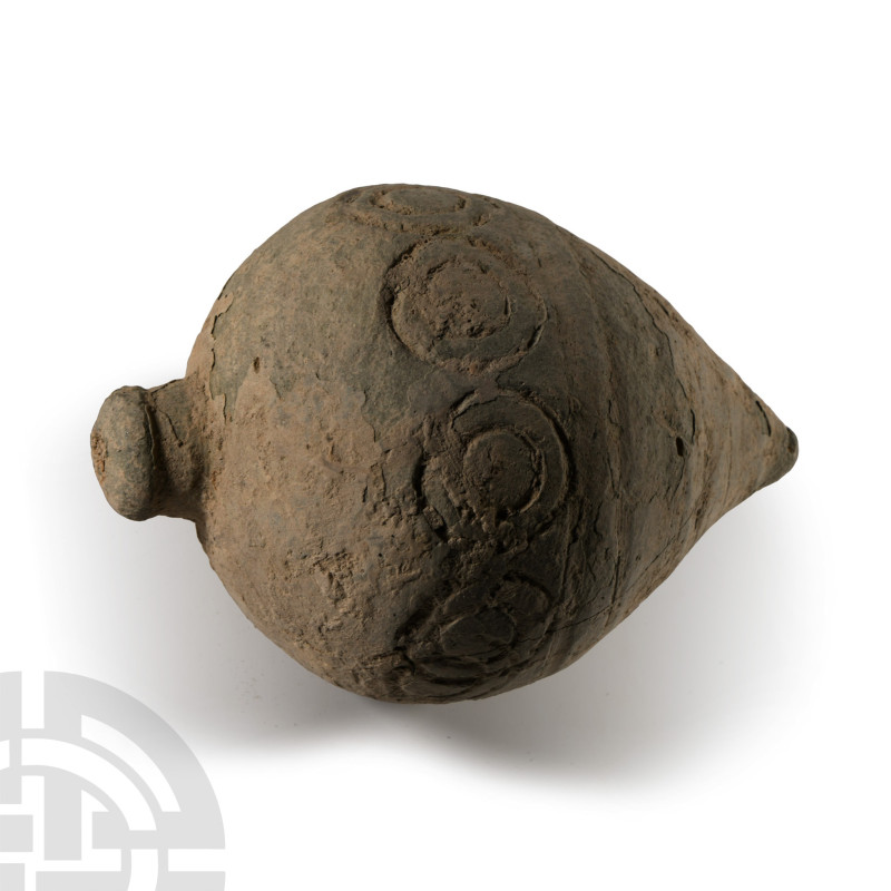 9th-11th century A.D.. A piriform ceramic missile with band of impressed roundel...