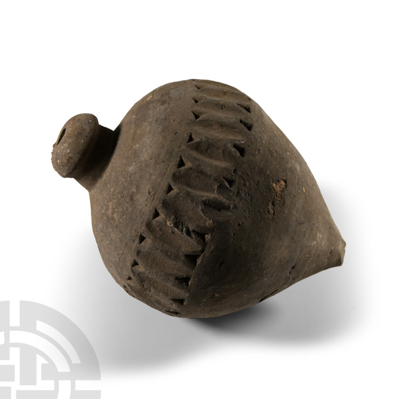 9th-11th century A.D.. A piriform ceramic missile with a band of impressed bars ...