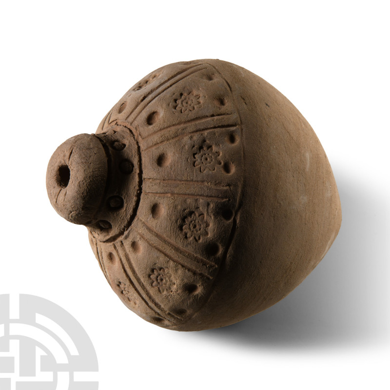 9th-11th century A.D.. A small ceramic missile with segmented shoulder and impre...