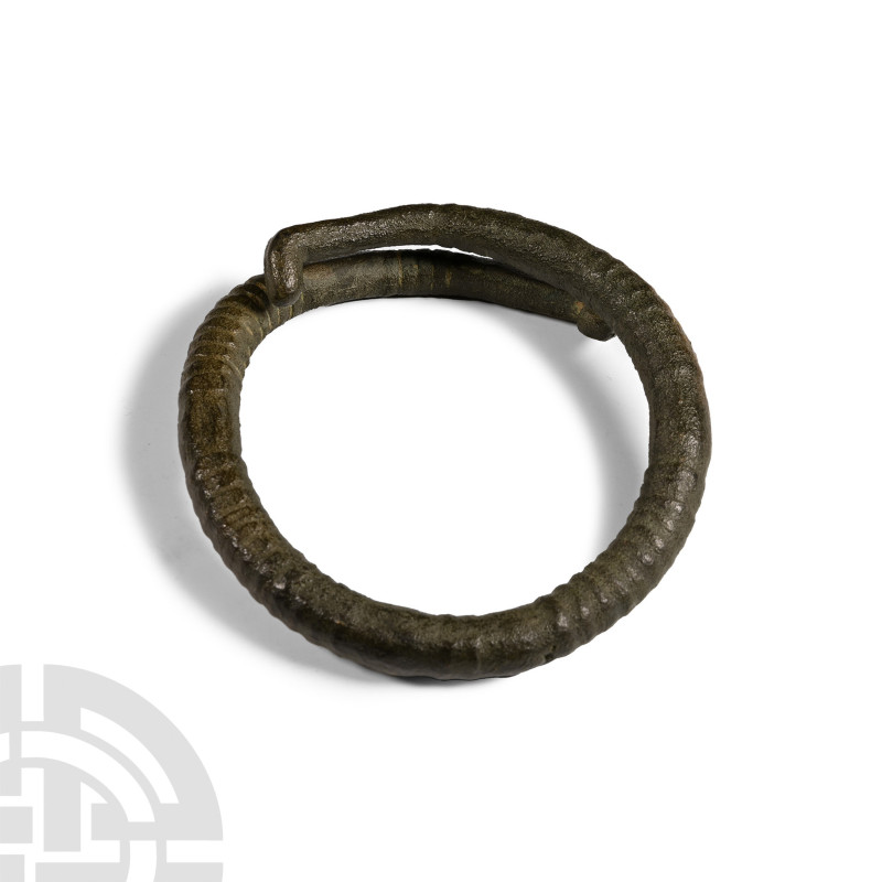 1st millennium B.C.. With round-section ribbed body and hooked terminals. 162 gr...