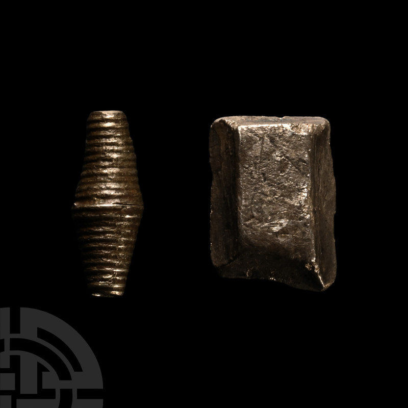 8th-11th century A.D.. Comprising: a fusiform bead with ribbed outer surface; ro...