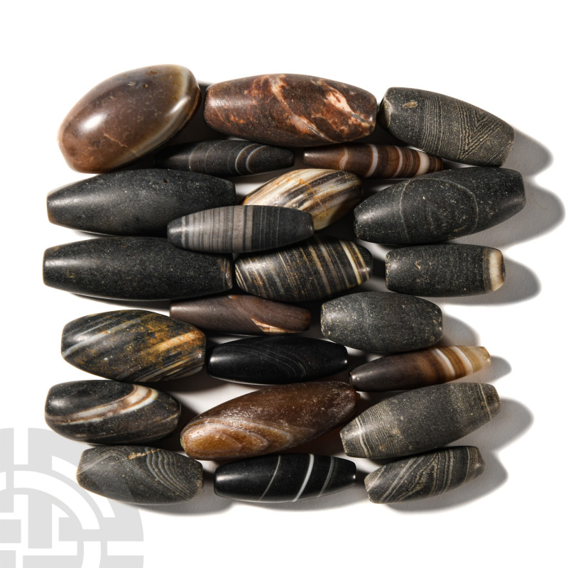 20th century A.D.. Comprising a group of oval banded agate beads; each pierced f...