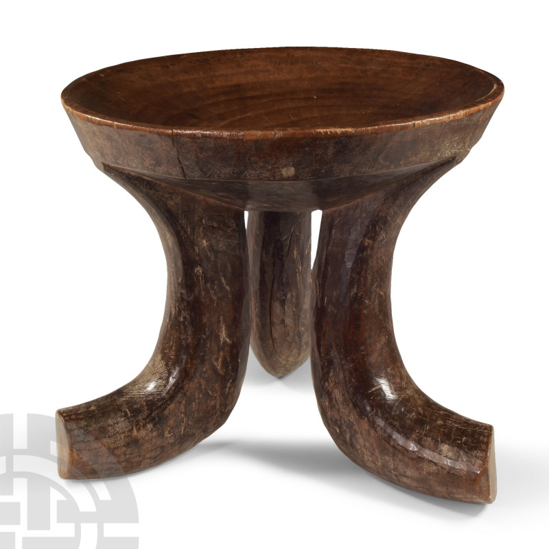 19th-20th century A.D.. With concave seat and three curved legs with integral fe...