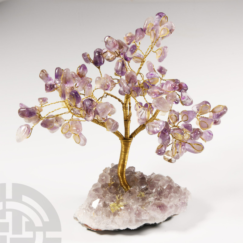 On an amethyst geode matrix; the metal branches tipped with polished light-colou...