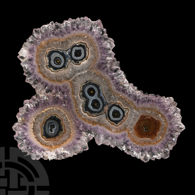 Cut and polished slice with amethyst encrusted edges, the agate banding forming ...