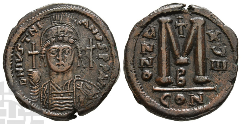Justinian I AE Follis. AD 527-565. D N IVSTNI-ANVS(sic) P P AVG, helmeted and cu...