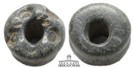 Near East. Circa 1st Millennium BC. Spindle whorl. Black steatite. 25 mm x 15 mm. 19.81 g.