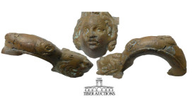 Roman. Circa 1st-4th Century AD. Vase handle, cast and decorated with cherubs and cupid. Bronze. 110 mm x 50 mm x 60 mm. 300g.