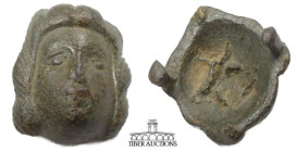 Roman. Circa 1st-4th Century AD.. Applique, female head. Bronze. 26 mm x 25 mm x 12 mm. 16.22 g.
