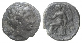 Bruttium, Terina, c. 300 BC. AR Drachm (15mm, 2.10g, 11h). Head of nymph r.; triskeles behind. R/ Nike seated l. on plinth, holding kerykeion. Hollowa...