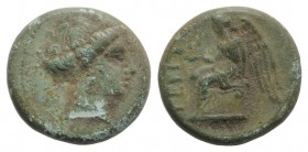 Bruttium, Terina, c. 350-275 BC. Æ (12 mm, 1.88g, 12h). Female head r. R/ Nike seated l. on cippus, holding bird. HNItaly 2651; SNG ANS -. Green patin...