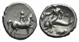 Southern Apulia, Tarentum, c. 272-240 BC. AR Nomos (19mm, 6.27g, 10h). Youth on horseback r., crowning horse with wreath; ΛEΩN below. R/ Phalanthos ri...