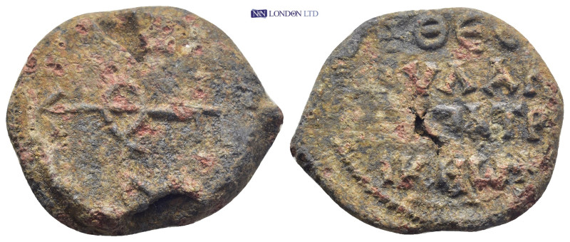 Byzantine Lead Seal, (26mm, 14.7 g) Cruciform monogram. / Legends in three lines...