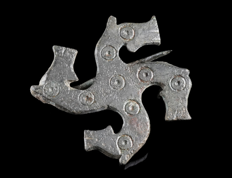 A LARGE ROMAN BRONZE SWASTIKA BROOCH WITH HORSE HEADS
Circa 2nd-3rd century AD....