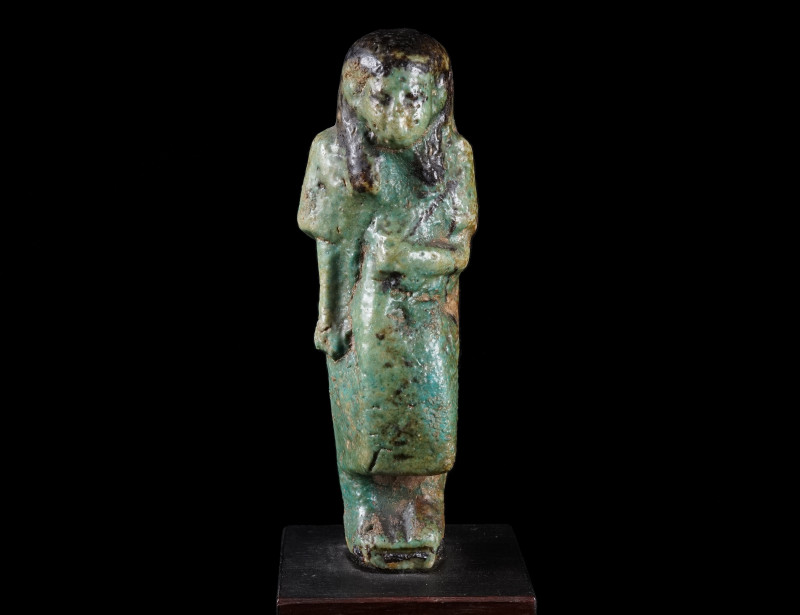 AN EGYPTIAN FAIENCE OVERSEER SHABTI
Third Intermediate Period, circa 1069-664 B...