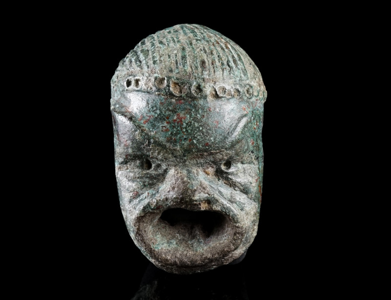 A ROMAN BRONZE THEATRE MASK BROOCH
Circa 2nd-3rd century AD.
Brooch in the sha...