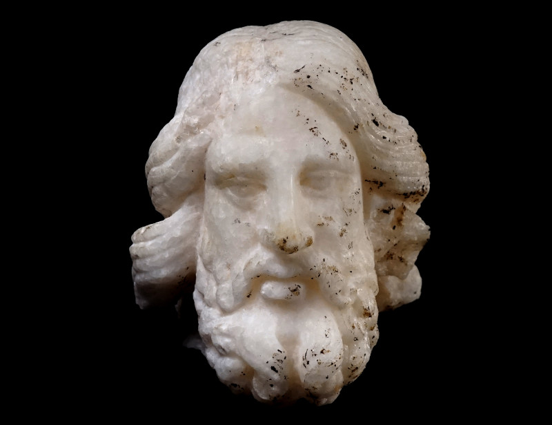 A ROMAN MARBLE HEAD OF ASCLEPIUS 
Circa 1st-2nd century AD.
The god is depicte...