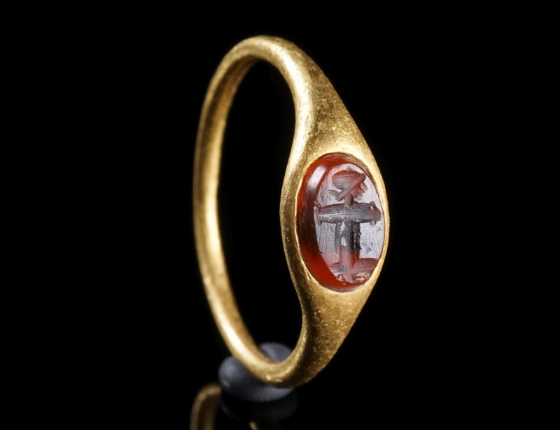 A ROMAN GOLD RING WITH A CARNELIAN INTAGLIO
Circa 1st-2nd century AD.
Ring wit...