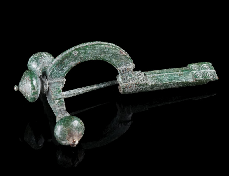 A LATE ROMAN BRONZE CROSSBOW BROOCH
Circa 4th century AD.
With arched bow and ...