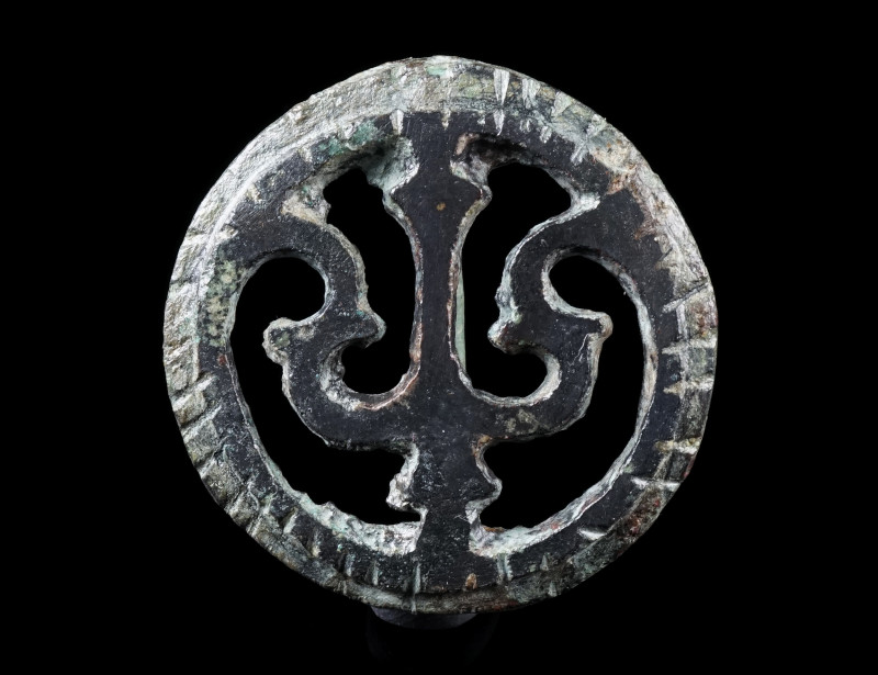 A ROMAN BRONZE OPENWORK DISK BROOCH
Circa 2nd-3rd century AD.
With an openwork...