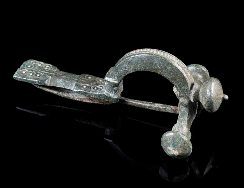 A LATE ROMAN BRONZE CROSSBOW BROOCH
Circa 4th century AD.
With arched bow and ...