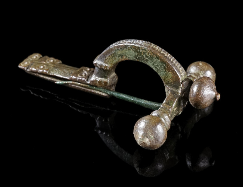 A LATE ROMAN BRONZE CROSSBOW BROOCH
Circa 4th century AD.
With arched bow and ...