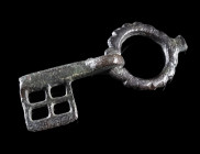 A BYZANTINE BRONZE FOLDING KEY
Circa 5th-6th century AD.
With hollow shank and an openwork key bit; attached to a ring with notched edges.
L 53 mm ...