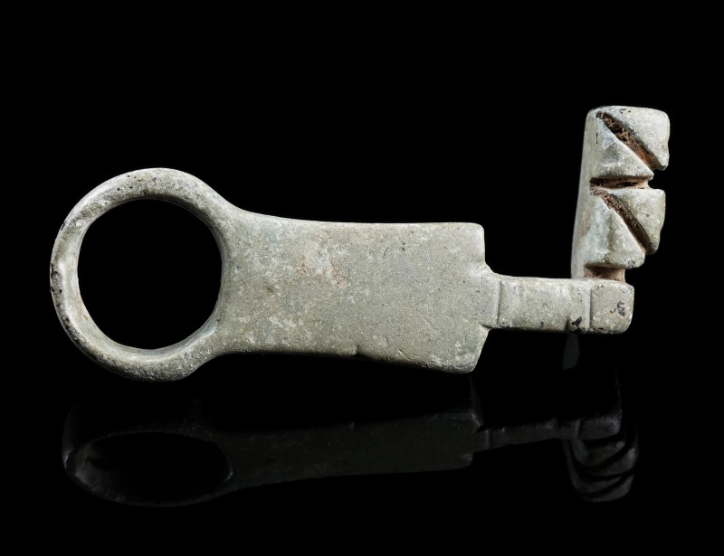 A ROMAN BRONZE KEY
Circa 1st-3rd century AD.
With a handle with loop and a sho...