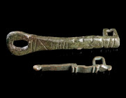 TWO ROMAN BRONZE HASPS
Circa 1st-3rd century AD.
Two hasps from chest/casket locks. The hinge/loop at the top and the rectangular strap loop on the ...