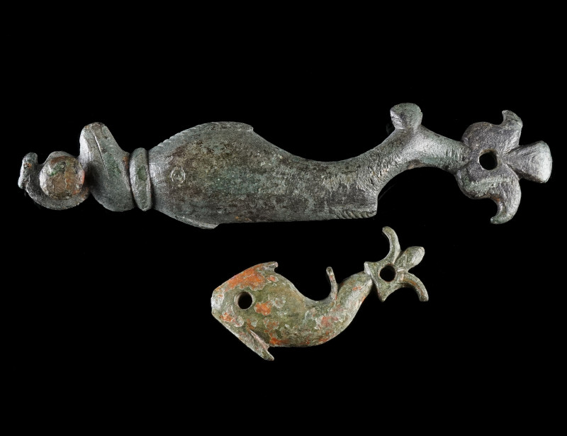 TWO ROMAN BRONZE APPLIQUES IN THE SHAPE OF A DOLPHIN
Circa 2nd-3rd century AD....