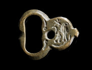 A BYZANTINE BRONZE BELT BUCKLE WITH A LION
Circa 6th-7th century AD.
The plate decorated with an engraved lion, a star above; two lugs for fixing to...