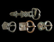 A GROUP OF FOUR ROMAN / BYZANTINE BRONZE BUCKLES
Circa 4th-7th century AD.
Various forms and types; all with thorn and rivets/lugs preserved.
L 21-...