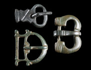 THREE LATE ANTIQUE / BYZANTINE BRONZE BELT BUCKLES
Circa 5th-7th century AD.
Various forms and types; all with thorn.
L 25-35 mm

Ex European pri...