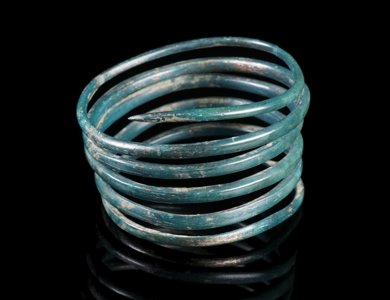 A EUROPEAN LATE BRONZE AGE SPIRAL ARMBAND
Circa 1200-800 BC.
Bronze spiral wit...