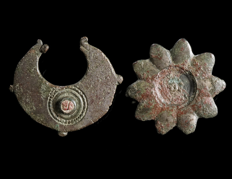 TWO EARLY ROMAN BRONZE BROOCHES 
Circa 1st century AD. 
A star-shaped brooch, ...