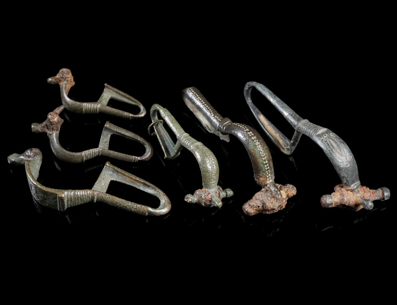 A GROUP OF SIX BYZANTINE BRONZE BROOCHES WITH BENT FOOT
Circa 6th-7th century A...