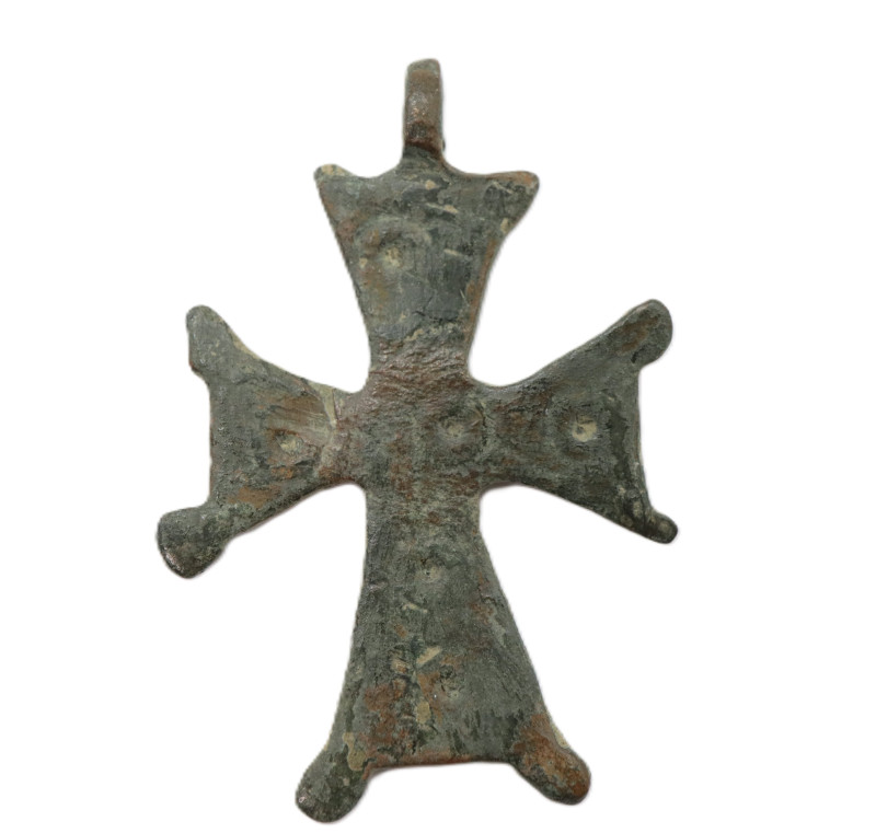 A bronze cross pendant with four expanding arms and dotted decoration on the obv...