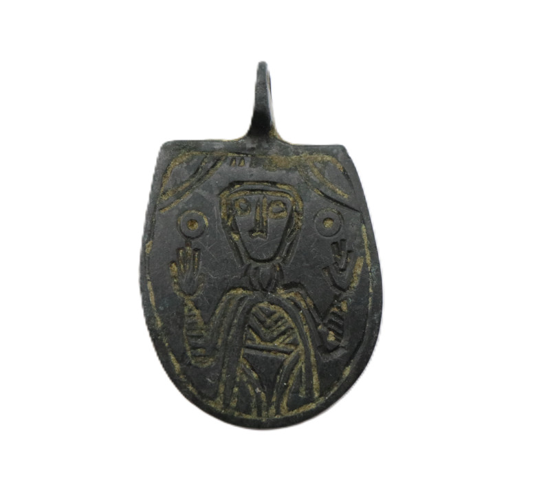 A bronze pendant with the engraved image of saint or emperor with open arms ; th...