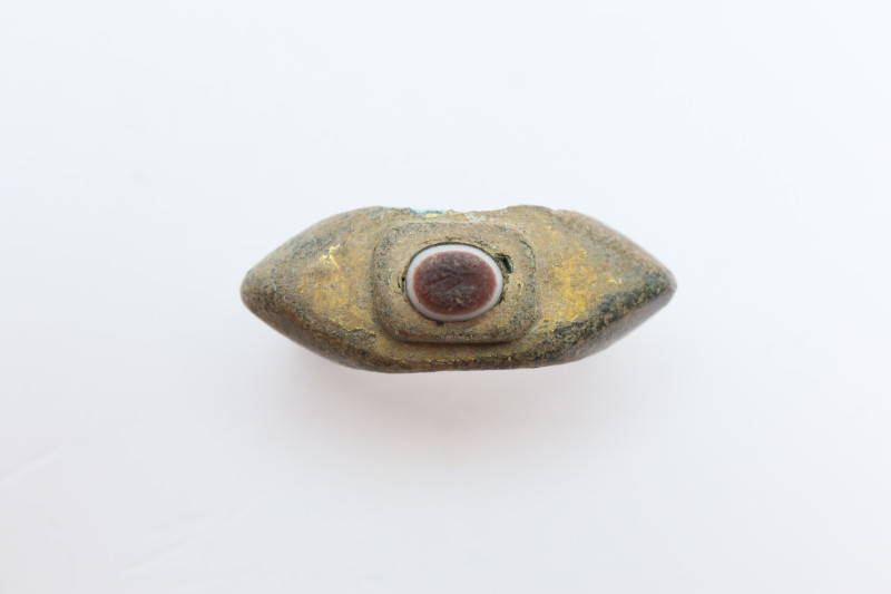 A solid bronze ring with expanding shoulders, elevated bezel holding a gemstone....