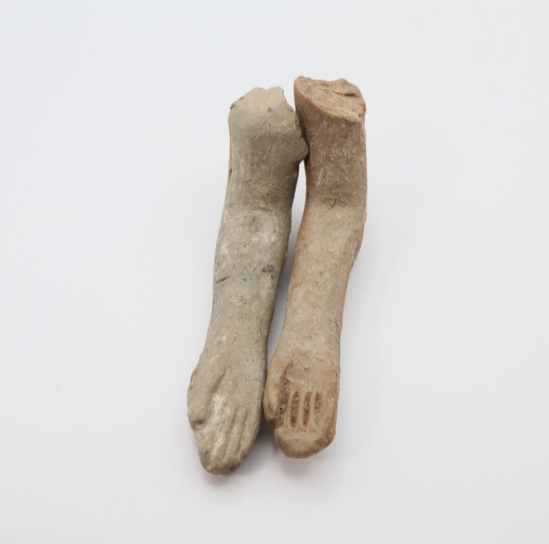 Comprising two terracotta arms with extended fingers; 65mm, 18 grams total. From...