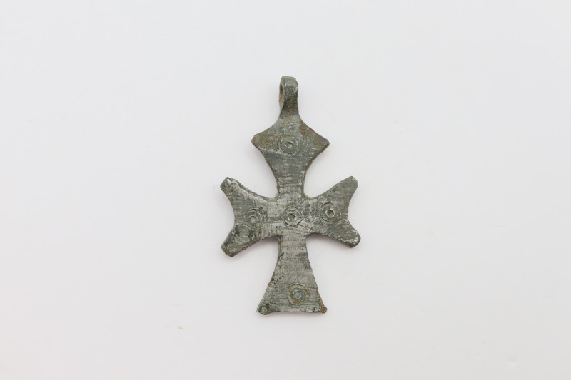 A silvered cross pendant with suspension loop and dotted decoration, loop intact...