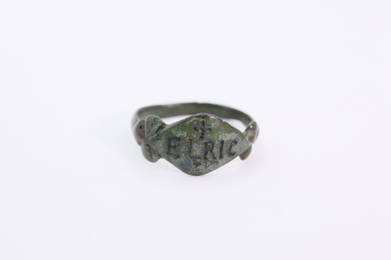 A bronze ring with solid band and possibly latter inscription ELRIC; 21.30mm dia...