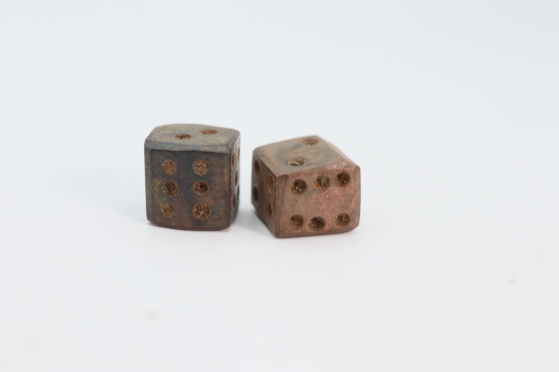 The cube with incised dotted rings on each facet numbering 1 to 6; approximately...