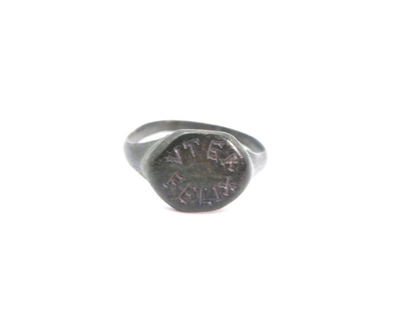 A bronze finger ring with oval bezel engraved with the Latin ''VTER FELIX'', mea...