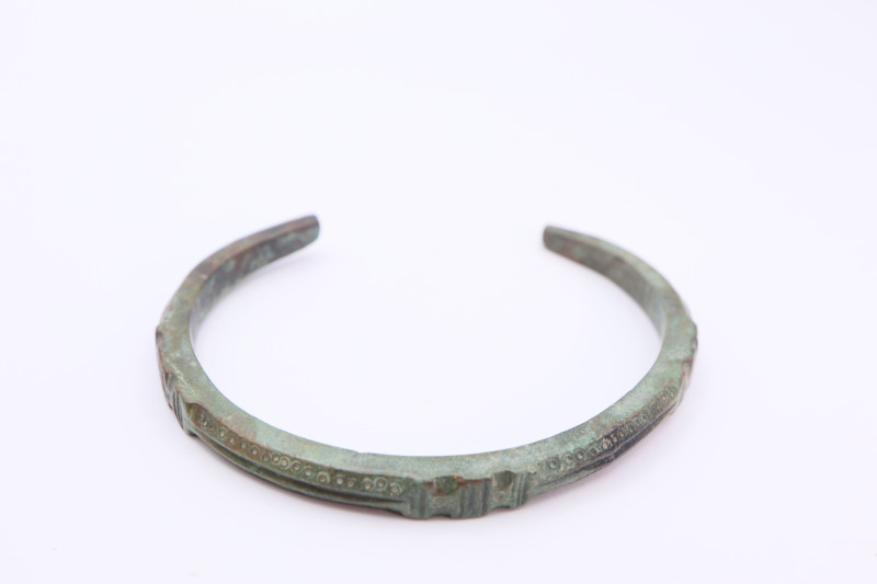 A substantial bronze bracelet with overall decoration, green patina intact; 34.2...